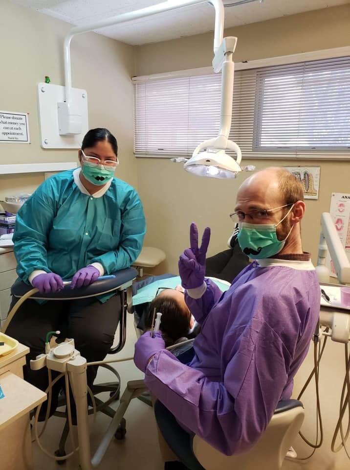 Dentist and assistant with patient